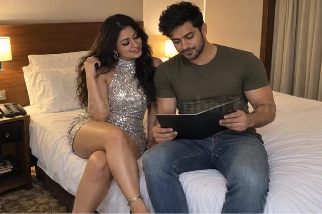 A woman in a short silver sequin dress sitting next to a man who reads a room-service menu in a Mumbai hotel room